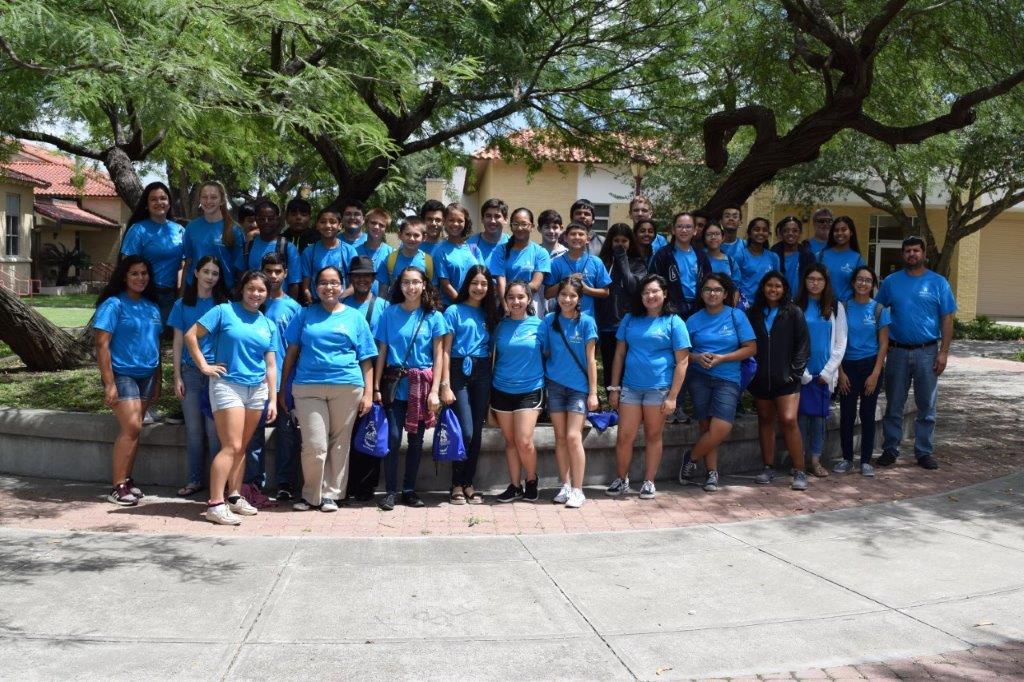 Students pose for camera outside