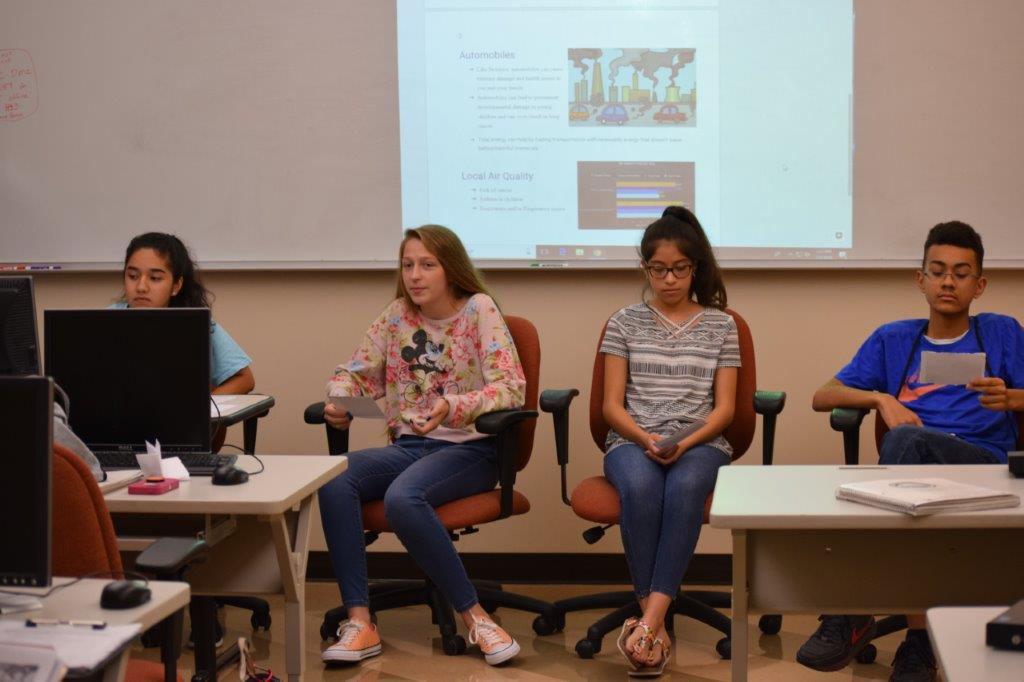 Students sit at the front of a classroom