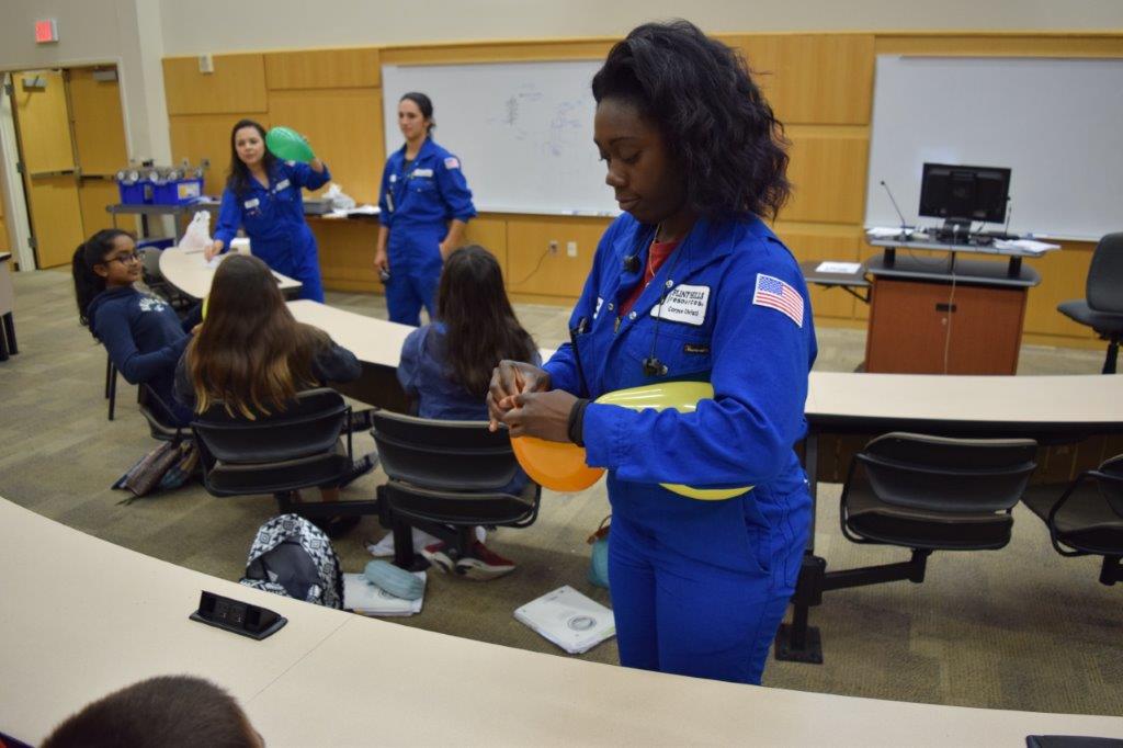 FHR employee ties a balloon in the classroom