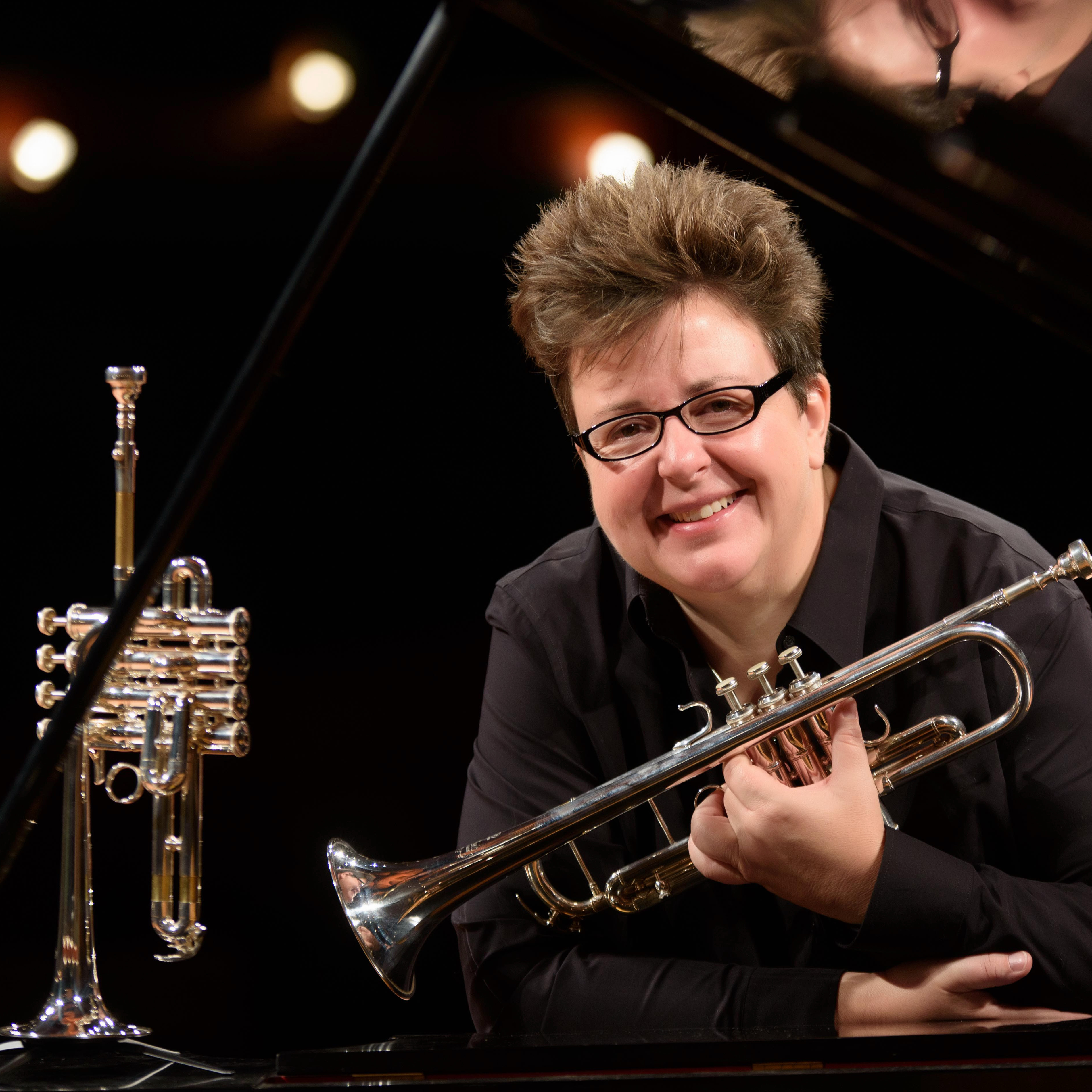 Mary Thorton smiling holding her trombone