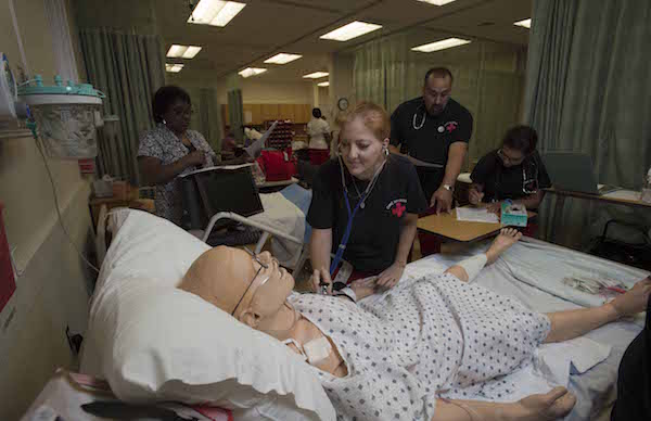 Student practicing checking the heart rate