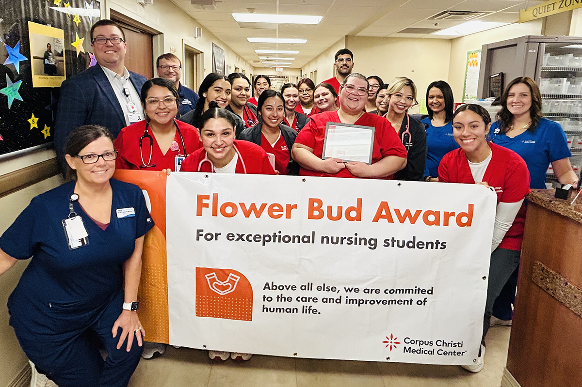 Kathryn Torres surrounded by other nursing students and employees at nursing facility