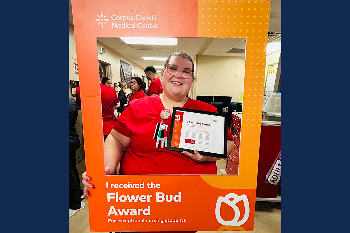 Kathryn Torres holding her student award