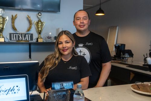 man and woman standing behind counter
