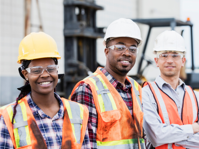 multi ethnic and gender construction crew with safety vest and hardhat