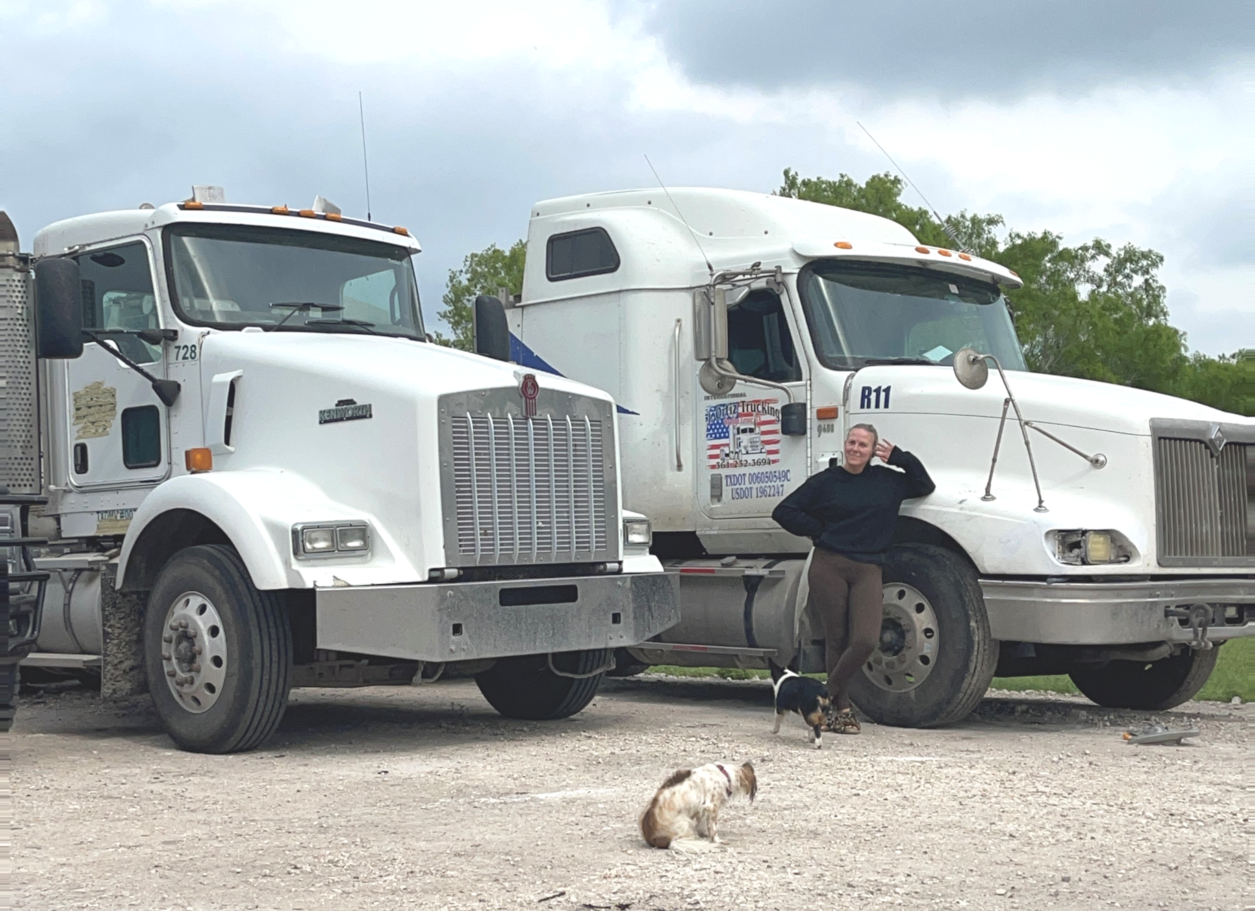 Shelly Ortiz standing with her eighteen wheeler trucks