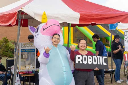 Robotics booth visitors in costumes